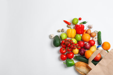 Paper bag with different groceries on white background, top viewの写真素材