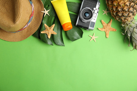 Flat lay composition with beach objects on green background. Space for textの写真素材