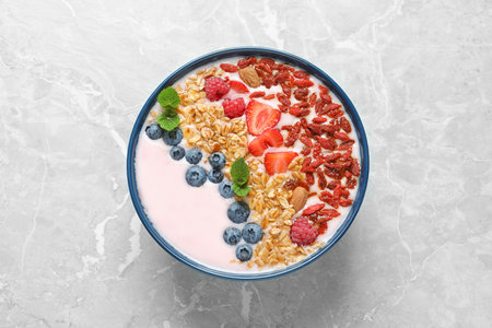 Smoothie bowl with goji berries on grey table, top viewの写真素材