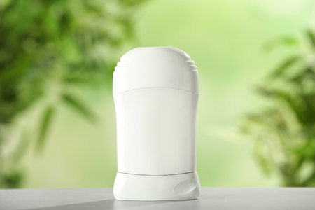 Deodorant container on white wooden table against blurred backgroundの写真素材