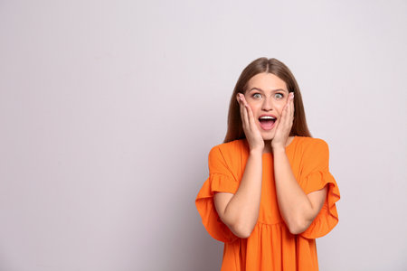 Portrait of surprised young woman on white backgroundの写真素材