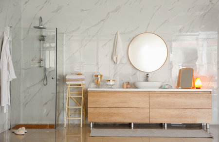 Modern bathroom interior with shower stall, vessel sink and round mirrorの写真素材
