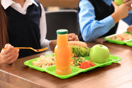 Children at table with healthy food in school canteen, closeupの写真素材