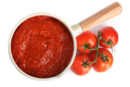 Delicious tomato sauce in pan isolated on white, top viewの写真素材