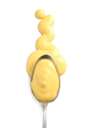 Delicious cheese sauce and spoon on white background, top viewの写真素材