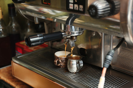 Preparing fresh aromatic coffee using modern machine at cafeの写真素材