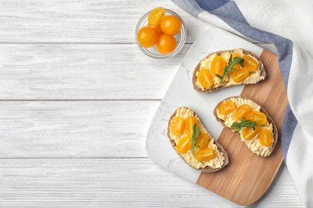 Tasty fresh tomato bruschettas on white wooden table, flat lay. Space for textの写真素材