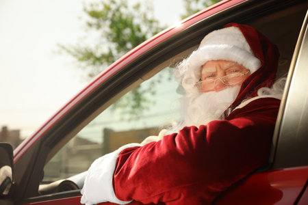 Authentic Santa Claus driving his modern car, outdoorsの写真素材