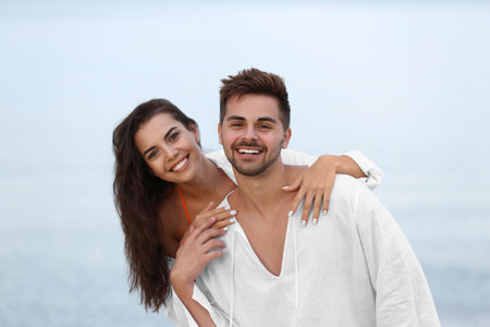 Happy young couple spending time together on the beachの写真素材