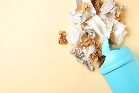 Trash bin and different garbage on color background, top view with space for text. Waste recycling conceptの写真素材
