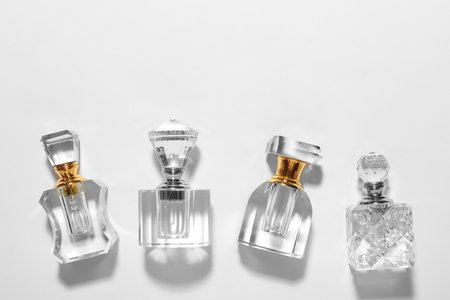 Different elegant perfume bottles on white background, top viewの写真素材