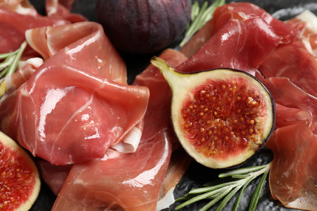Closeup view of delicious figs and prosciuttoの写真素材