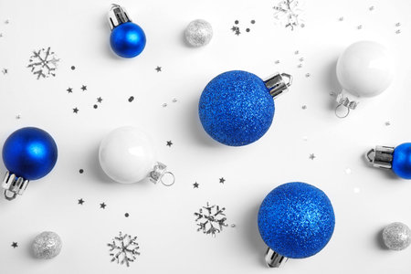 Colorful Christmas balls and sparkles on white background, top viewの写真素材