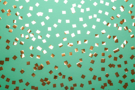 Confetti on green background, flat lay. christmas celebrationの写真素材