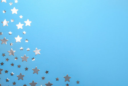 Confetti stars with space for text on blue background, top view. christmas celebrationの写真素材