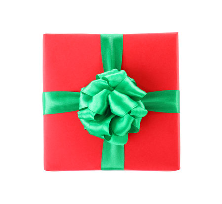 Christmas gift box decorated with ribbon bow on white background, top viewの写真素材