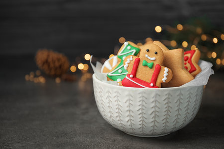 Tasty homemade Christmas cookies on dark gray table, space for text