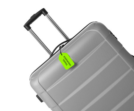 Gray suitcase with TRAVEL INSURANCE label on white backgroundの写真素材