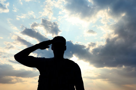 Soldier in uniform saluting outdoors. military serviceの写真素材