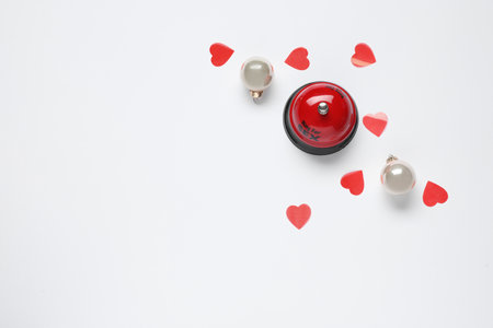 Service bell with words RING FOR SEX, Christmas balls and red hearts on white background, top viewの写真素材