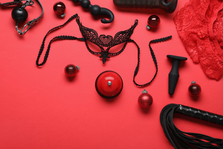 Set of different sex toys and Christmas balls on red background, flat layの写真素材