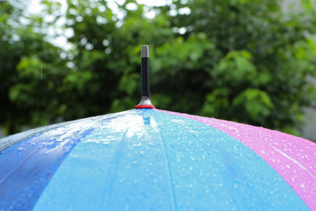Colorful umbrella outdoors on rainy day, closeupの写真素材