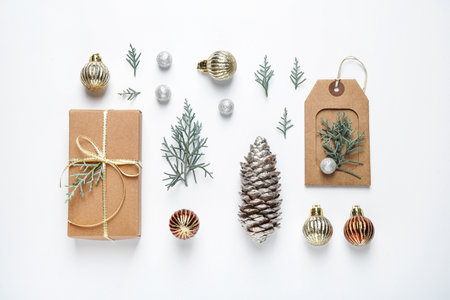 Flat lay composition with Christmas gift and festive decor on white backgroundの写真素材