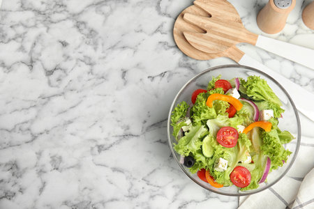 Tasty fresh Greek salad on white marble table, flat lay. Space for textの写真素材