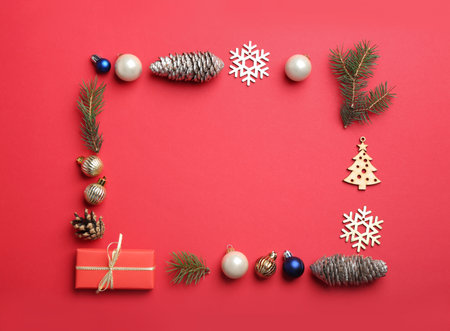 Frame made with Christmas decor on red background, flat lay. Space for textの写真素材