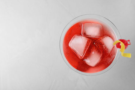 Glass of tasty refreshing cocktail on gray background, top view. Space for textの写真素材