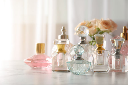 Many different perfume bottles on dressing table, space for textの写真素材