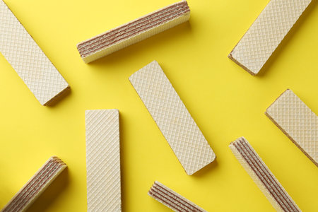 Tasty wafer sticks on yellow background, flat lay. sweet foodの写真素材