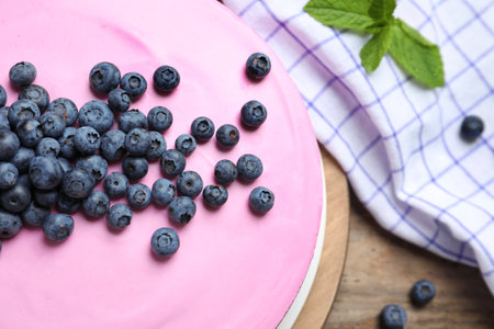 Board with tasty blueberry cake on wooden table, closeupの写真素材