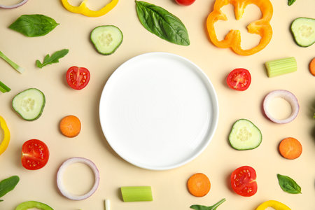 Flat lay composition with fresh salad ingredients on beige background, space for textの写真素材