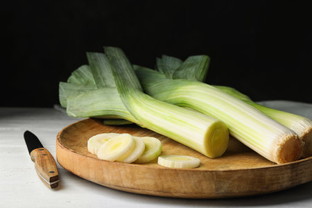 Fresh raw leeks on white wooden table. Ripe onionの素材 [FY310210043281]