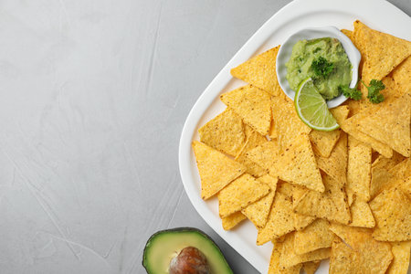 Flat lay composition with tasty Mexican nachos chips on gray table, space for textの写真素材