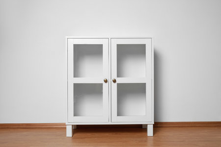 Empty wooden cabinet near white wall. Stylish home furnitureの写真素材