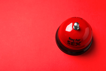Sex bell on red background, above view. Space for textの写真素材