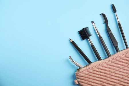 Set of professional eyebrow tools on blue background, flat lay. Space for textの写真素材