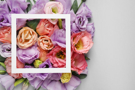 Flat lay composition with beautiful Eustoma flowers on gray backgroundの写真素材
