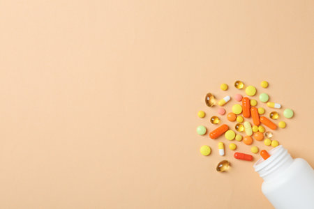 Bottle, different pills and space for text on color background, top viewの写真素材