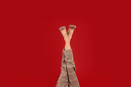 Woman in elegant shoes on red backgroundの写真素材