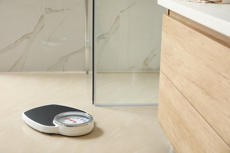 Scales on floor in bathroom. overweight problemの写真素材