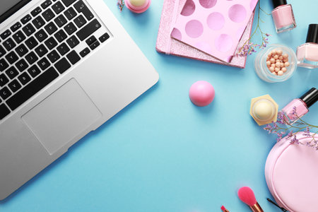 Flat lay composition with laptop on blue background. Beauty blogger's workplaceの写真素材