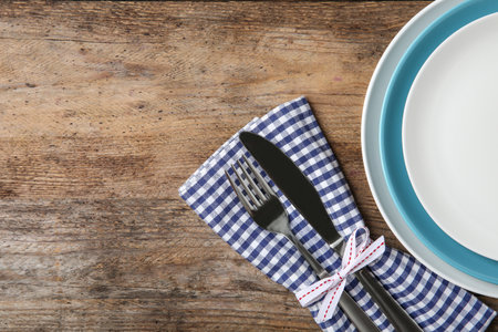 Beautiful table setting on wooden background, flat lay. Space for textの写真素材