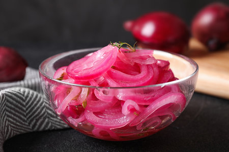 Bowl with tasty pickled onions on black table, closeupの写真素材