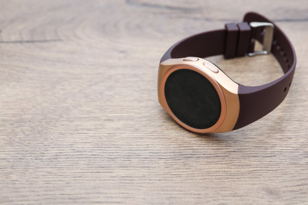 Modern smart watch on wooden background. Space for textの写真素材