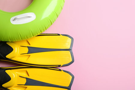 Flat lay composition with beach accessories on pink background, space for textの写真素材