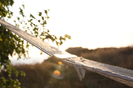Empty hammock hanging outdoors. Time to relax