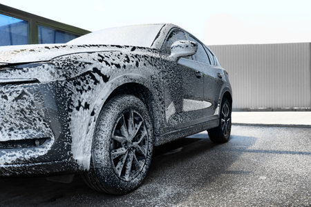 Clean auto with foam at self-service car washの写真素材
